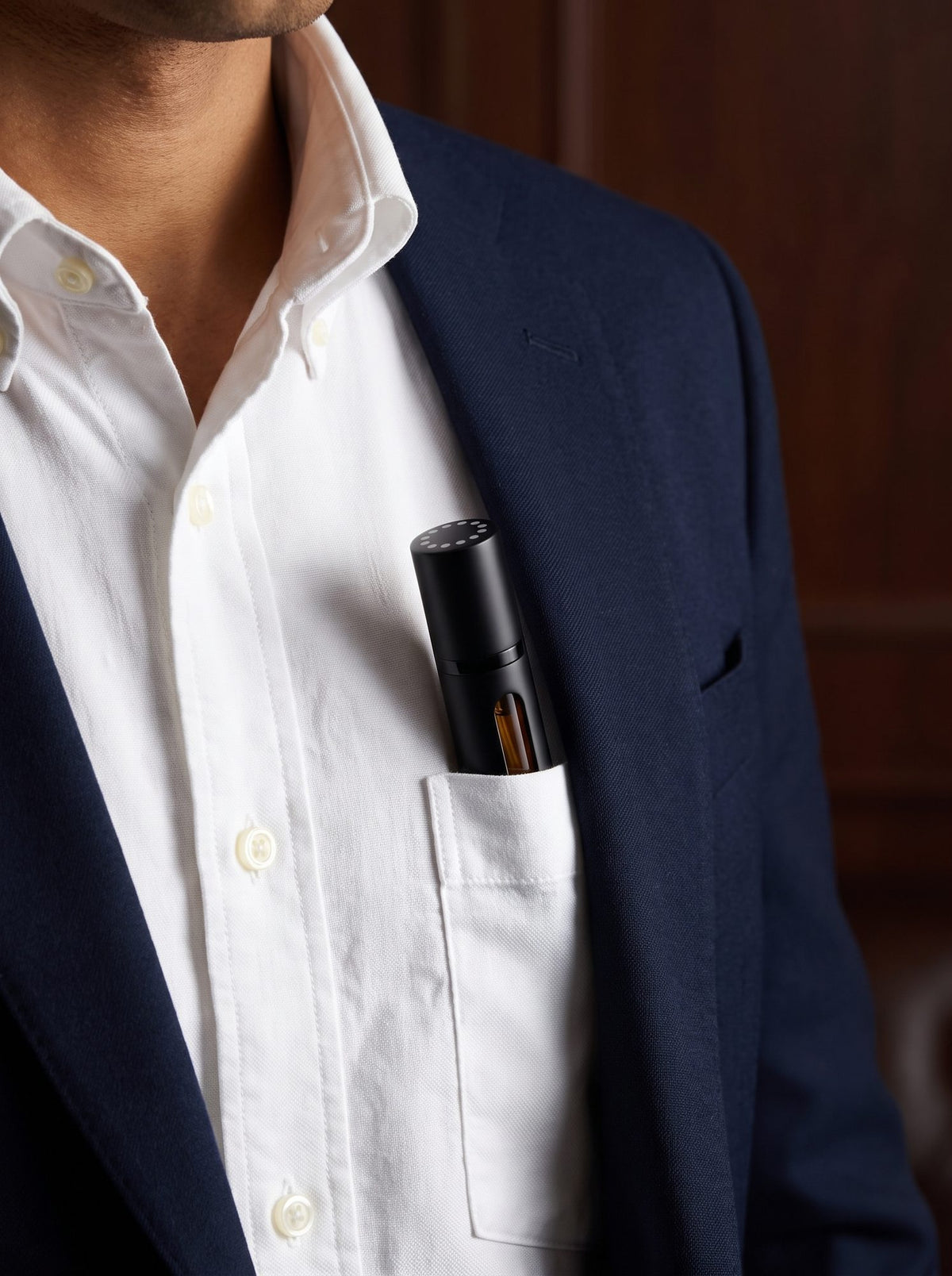 The EMANE travel spray in a shirt pocket, the size of a pen