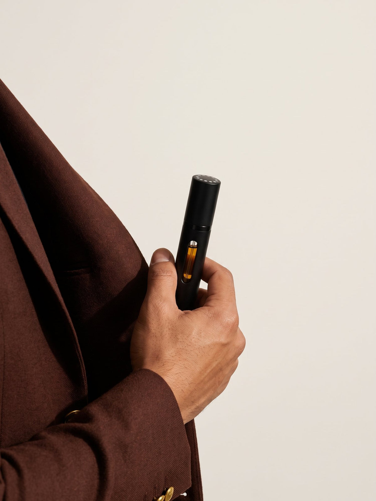 The travel spray slipped into a jacket pocket