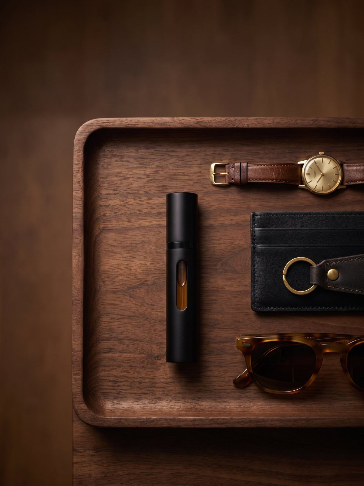 The travel spray on a valet tray with a watch and card holder